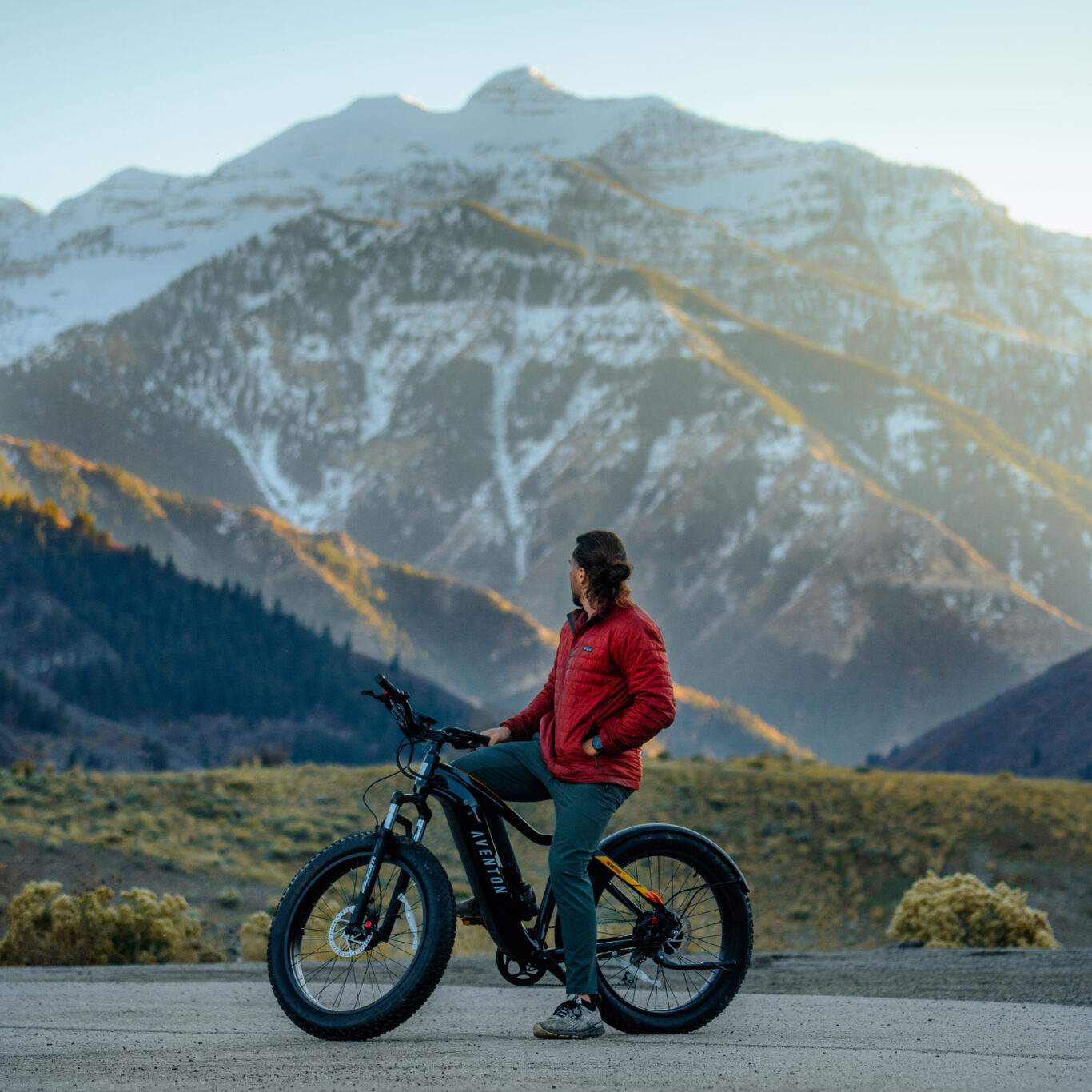 Guest enjoying an e-bike with a mountain backdrop